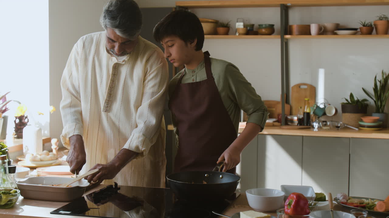Father and Son Cooking Together in a Modern Kitchen