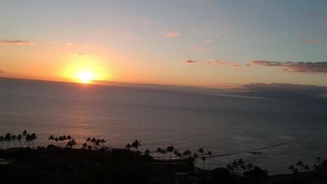 aerial drone footage of the surf off the coast in kihei maui hawaii rising up into the air in 1080 during sunset