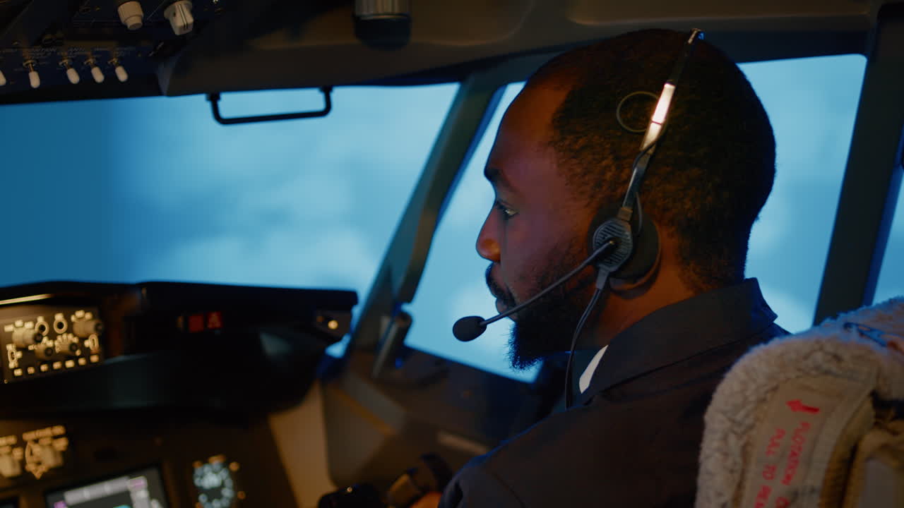 African american copilot using airplane command to fly plane