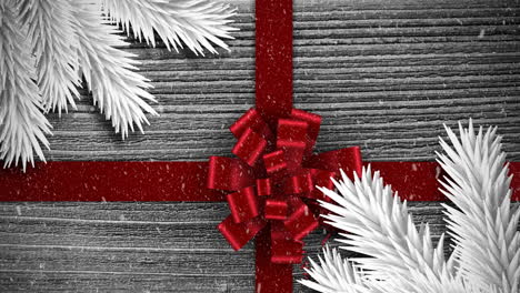 Animation-of-christmas-red-present-ribbon-with-snow-falling-on-grey