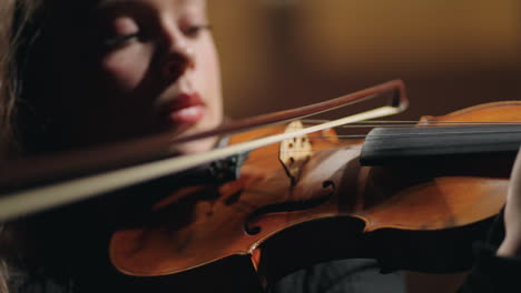 closeup portrait of female violinist in old opera house woman is playing violin