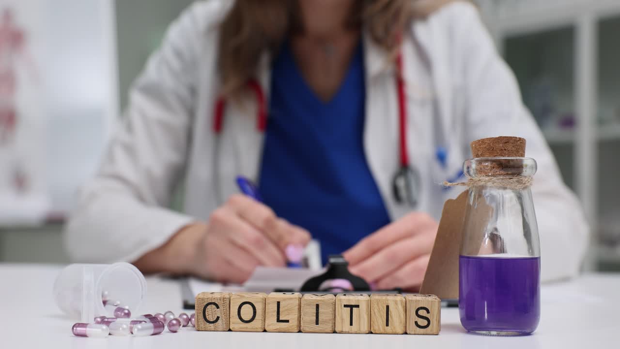 Wooden blocks spell colitis as doctor writes treatment notes