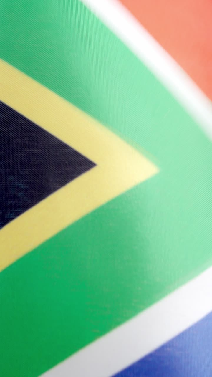 Vertical video of south african national flag waving by the wind