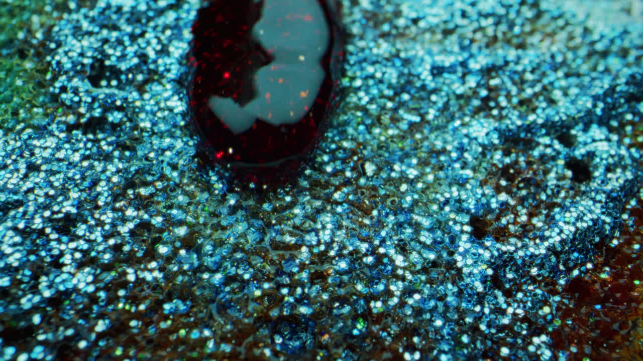 Abstract Glitter Liquid Texture with Red Drop