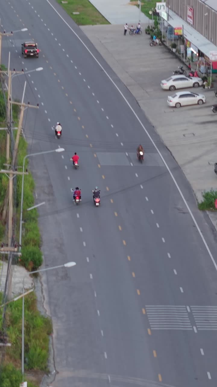 Aerial view of road traffic with motorcycles and cars