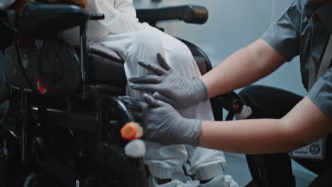 healthcare worker assisting a person in a wheelchair
