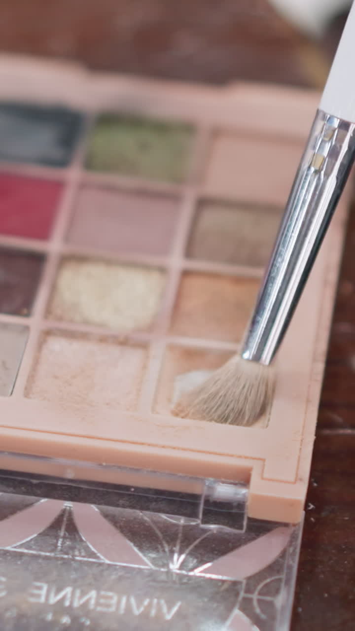 Demonstrating meticulous use of creamy products through textured blending methods, Exhibiting expertlevel makeup craftsmanship by manipulating textured pigments with precise tactile motions