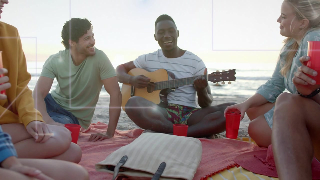 Male guitarist strumming and singing on beach at sunset, animated music notes rising around friends