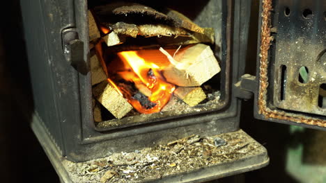 house heating by burning firewood in the metal stove