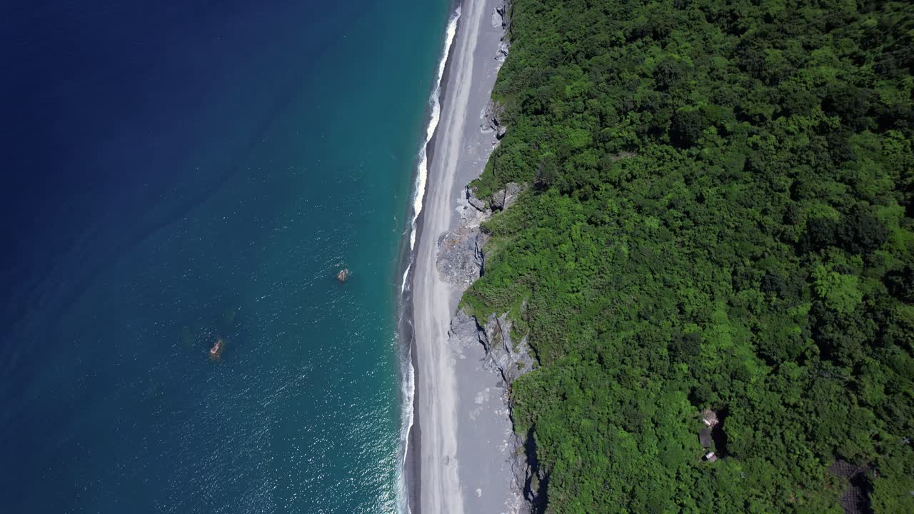 playa tropical cubierta de rocas caídas por la erosión gradual del acantilado en la costa este de taiwán - inclinación gradual del cardán hacia arriba