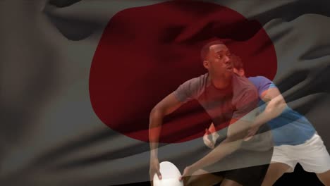 African American rugby player throwing the football away while being tackled down by Caucasian playe