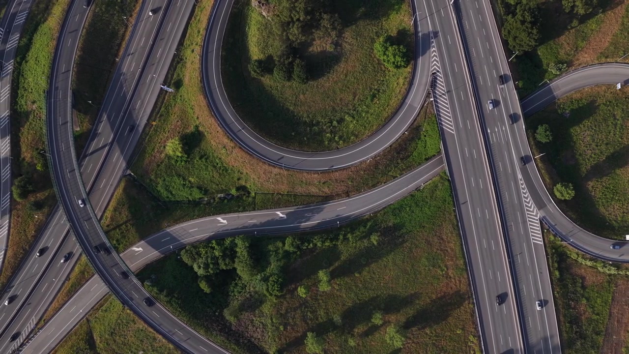 Aerial Sunset Shot of Highway Interchanges with Cars and Overpasses