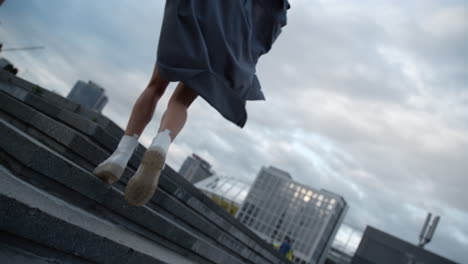 City-girl-walking-stairs-at-evening-or-dusk-downtown-urban-area.