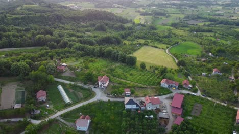 scenic aerial view of a bosnian village with green hills and forests