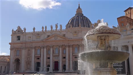 fountain flows in the center of st. peter’s square, framed by basilica and soft morning light.