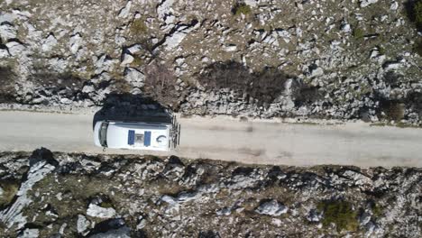 Top-down-follow-shot-of-motorhome-on-gravel-road