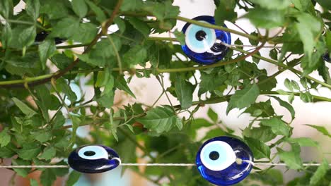 turkish evil eye beads hanging on a plant