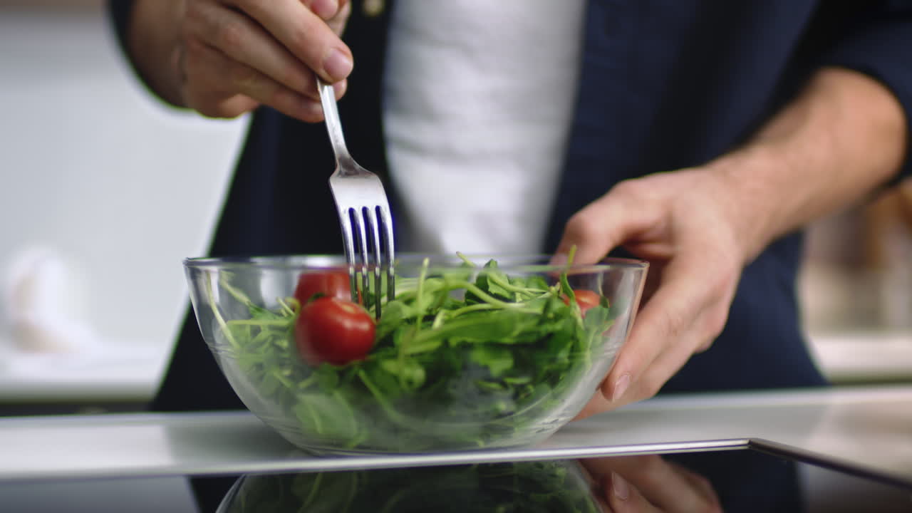 Close up view of man hands taking bowl with salad