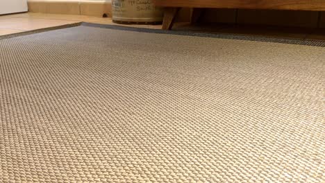 a hoovering robot is going through the living room floor on top of the carpet