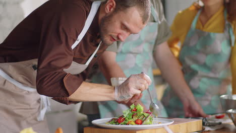 chef pouring salad dressing during cooking master class