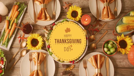 animation of happy thanksgiving day text and dinner on table background