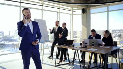 business people in office. young entrepreneurs working at new projects. successful businessman in suit talking the phone.