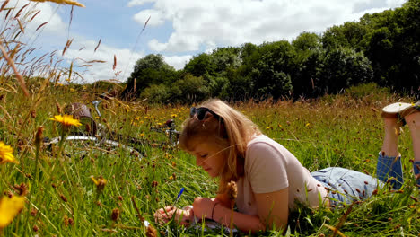 Woman-writing-on-notepad-in-field-4k