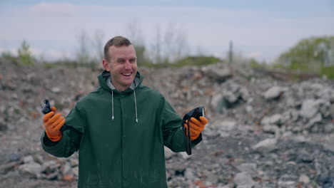 happy man without gas mask breathe in ruined place. ecologist in protective suit without respirator satisfied with a normal level of air after the chemical attack outdoors.