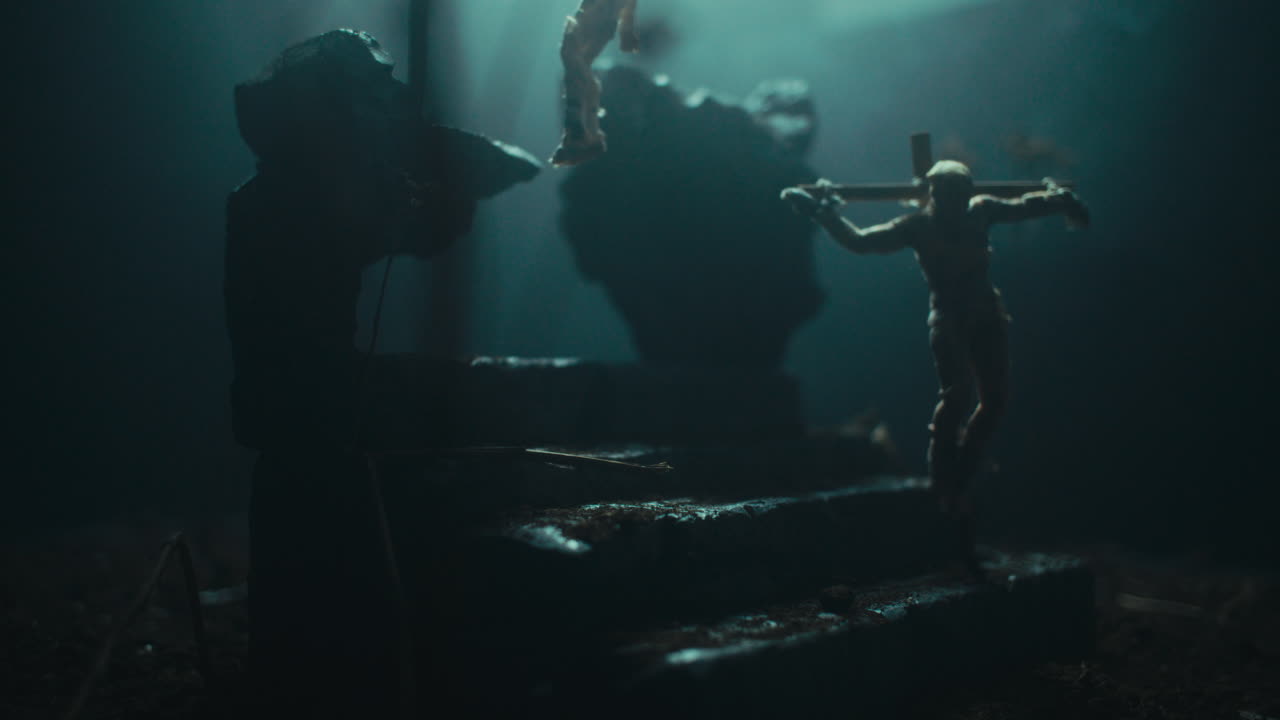 Miniature mummified dolls hanging on the gallows at night