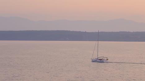 sunrise, sunset over open adriatic sea with coast visible in the background