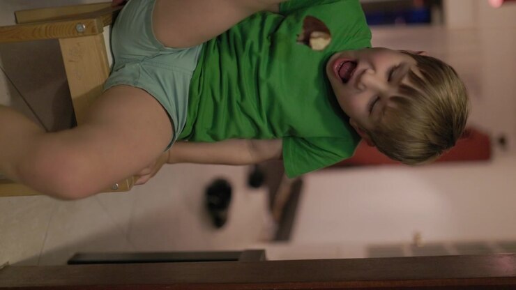 Little boy falling backwards from a stool in slow motion