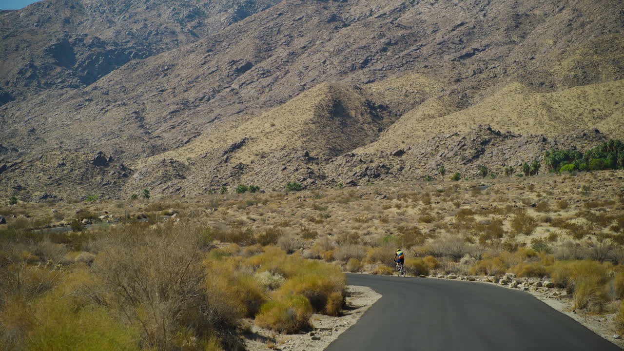 Biker in Palm Springs with the rugged San Jacinto Mountains rising behind them in California