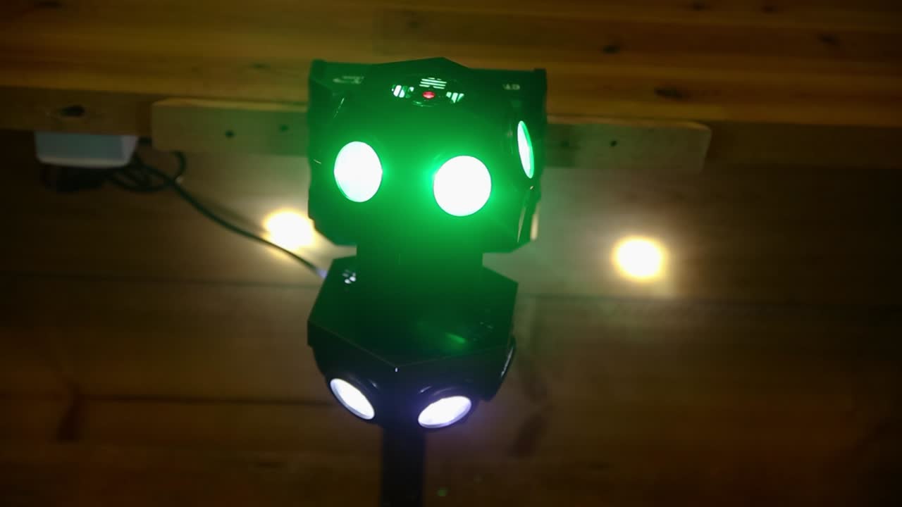 Close up gimbal shot of colorful spotlights hanging from ceiling