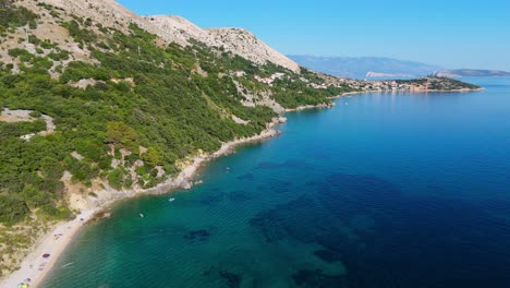 campsite at campig skrila, krk island, stara baska croatia, aerial view of the mountains and coast with boats, beaches and adriatic sea. the seaside rv campmobiles on a summer beautiful coastline