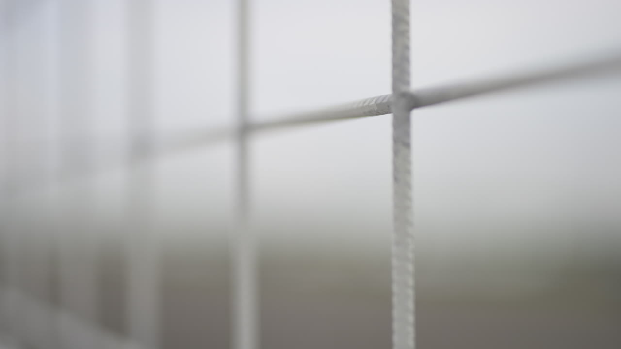 Shallow depth of focus of a fence; 50 fps slowed to 25