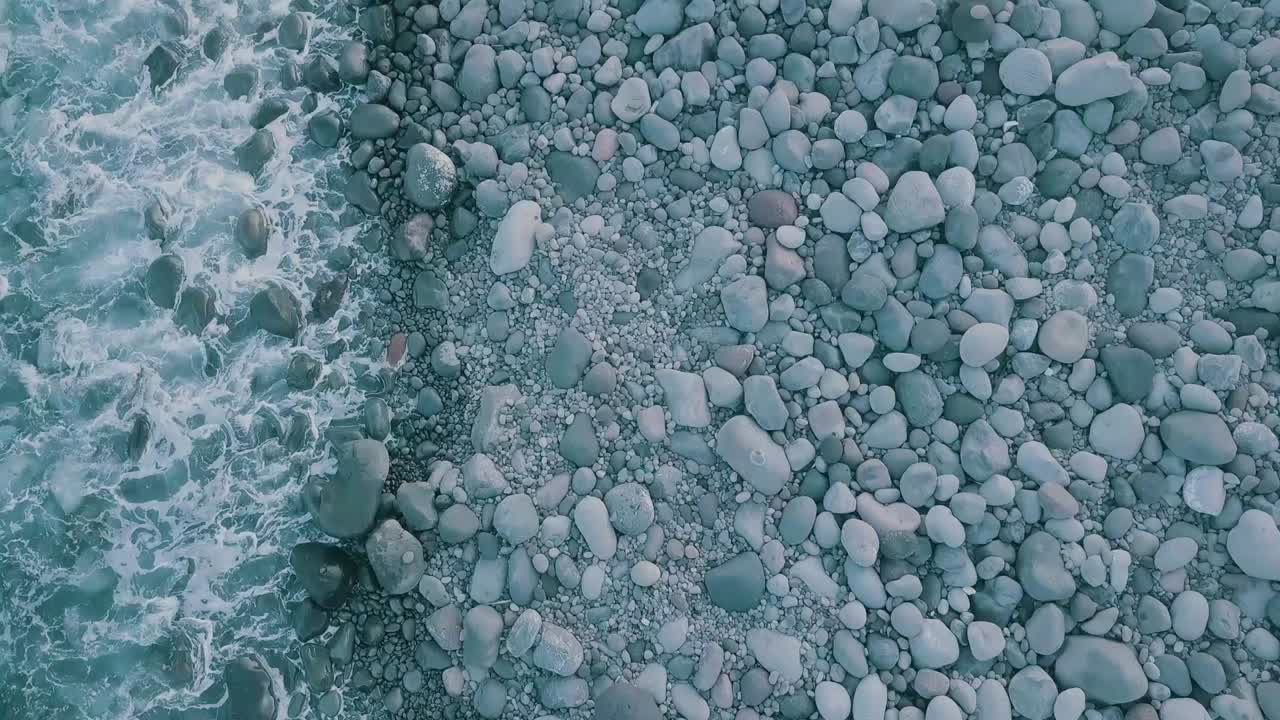 кинематографическое воздушное видео волн, бьющихся о большую груду камней поздним вечером на пляже валуган в батанесе, филиппины