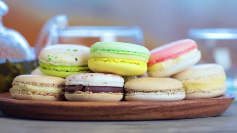 close-up of colorful macaron (macaroon) on the table with hot tea