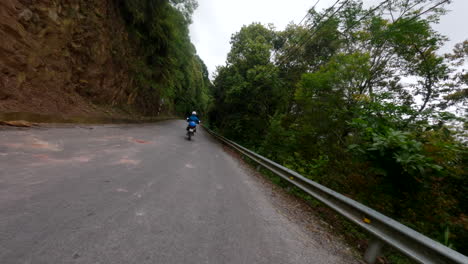 motorcycling on the epic mountain road in ha giang province, northern vietnam. tracking shot