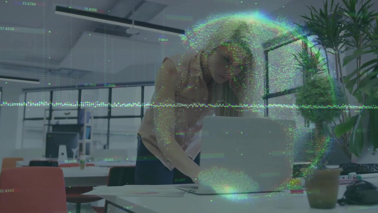 Analyst leaning on desk reading charts tapping laptop while rotating data overlays guiding analysis