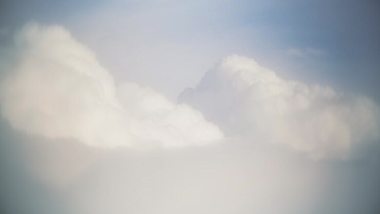 Flight over clouds, a view from a plane window - beautiful blue sky