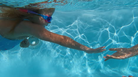 Girl-reaches-mother-underwater