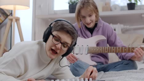 mother and daughter making music together at home
