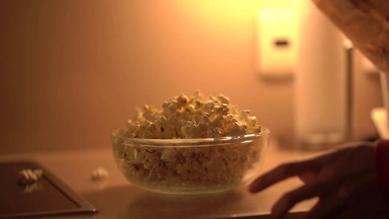 Serving popcorn in bowl. Close up of popcorn