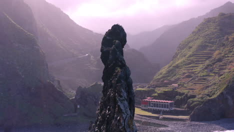 seascape with gigantic rock formation on coastline of madeira island during foggy and cloudy day