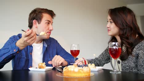 couple interacting while having cake