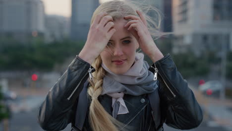 portrait successful young blonde woman tourist smiling running hand through hair enjoying independent travel lifestyle in city beautiful female commuter wind blowing hair slow motion