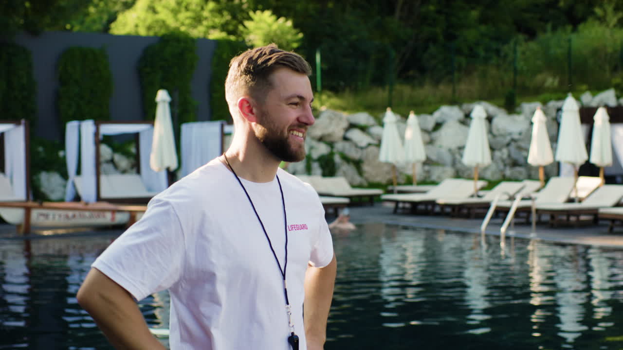 Lifeguard using whistle in the swimming pool
