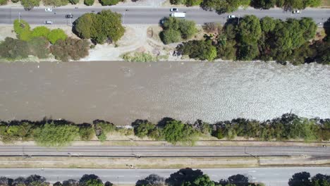 Birdseye-Aerial-View-of-Traffic-on-Roads-by-Medellin-River,-Colombia,-High-Angle-Drone-Shot