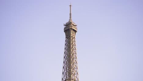 Eiffel-Tower-top-seen-in-daytime-from-the-Seine-river,-Looking-up-shot-from-boat