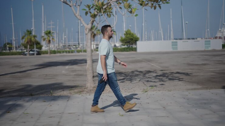 Man Walking in a City Harbor